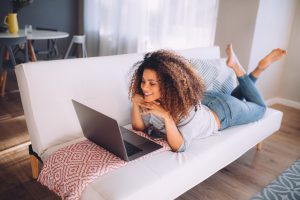 Woman on a couch with a laptop